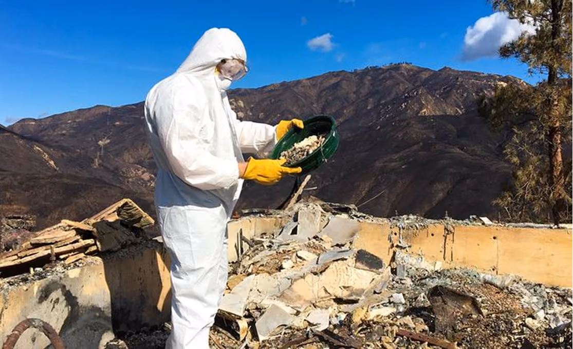 Operator inspecting a fire-affected landscape
